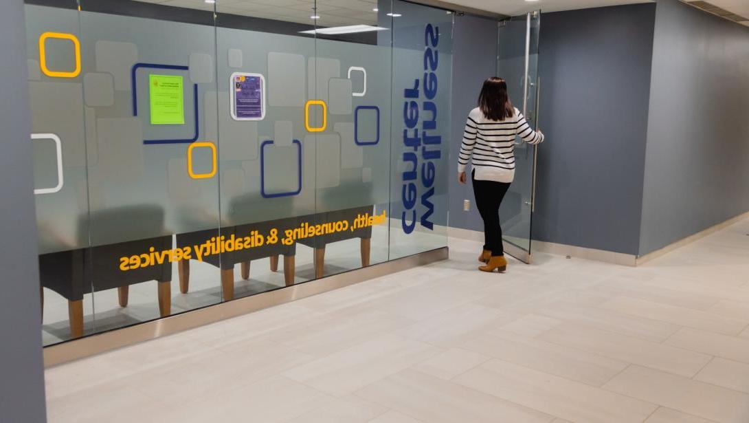 A student walks through the door of the Wellness Center on campus